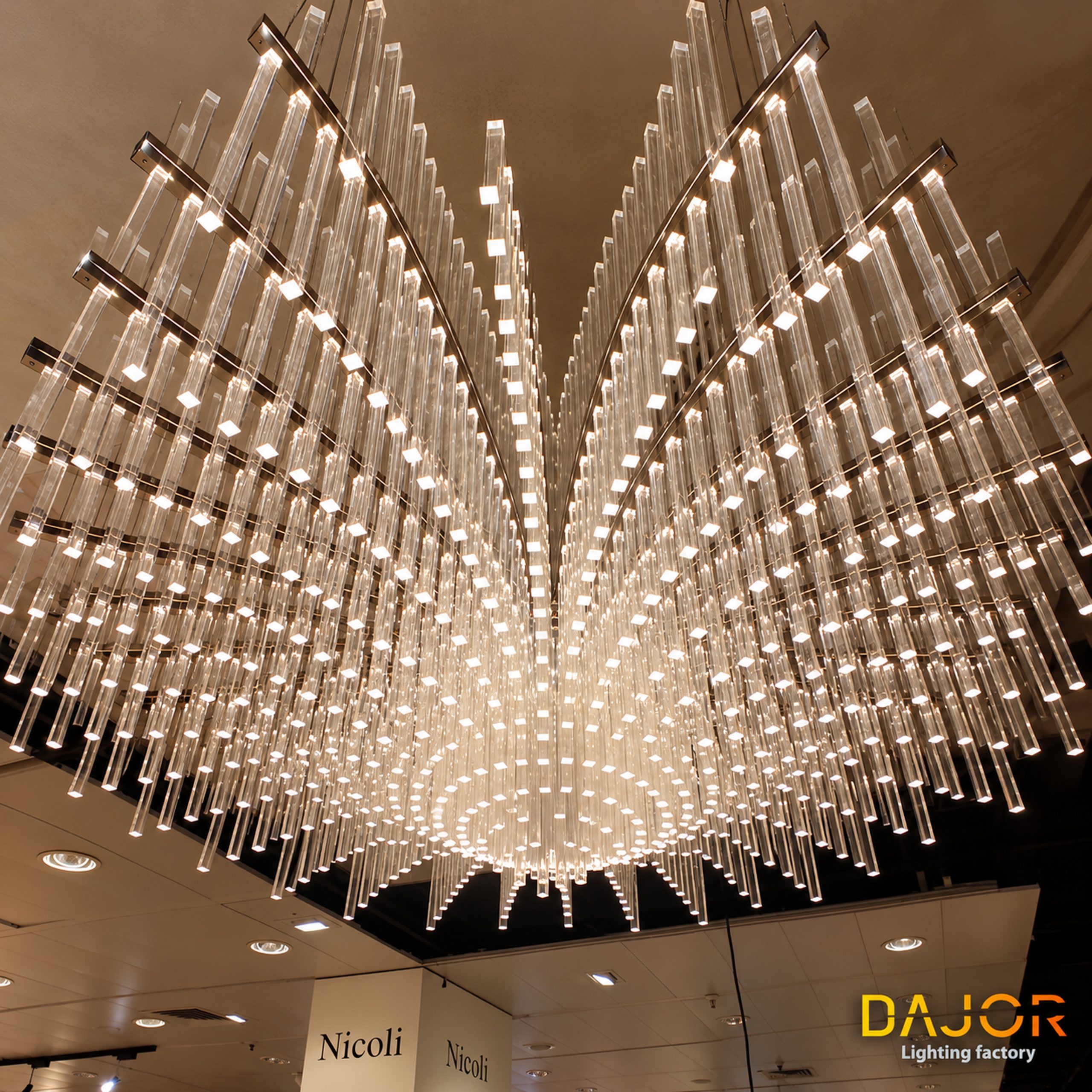 Varillas transparentes de diferentes longitudes con extremos iluminados, distribuidas en filas radiales.